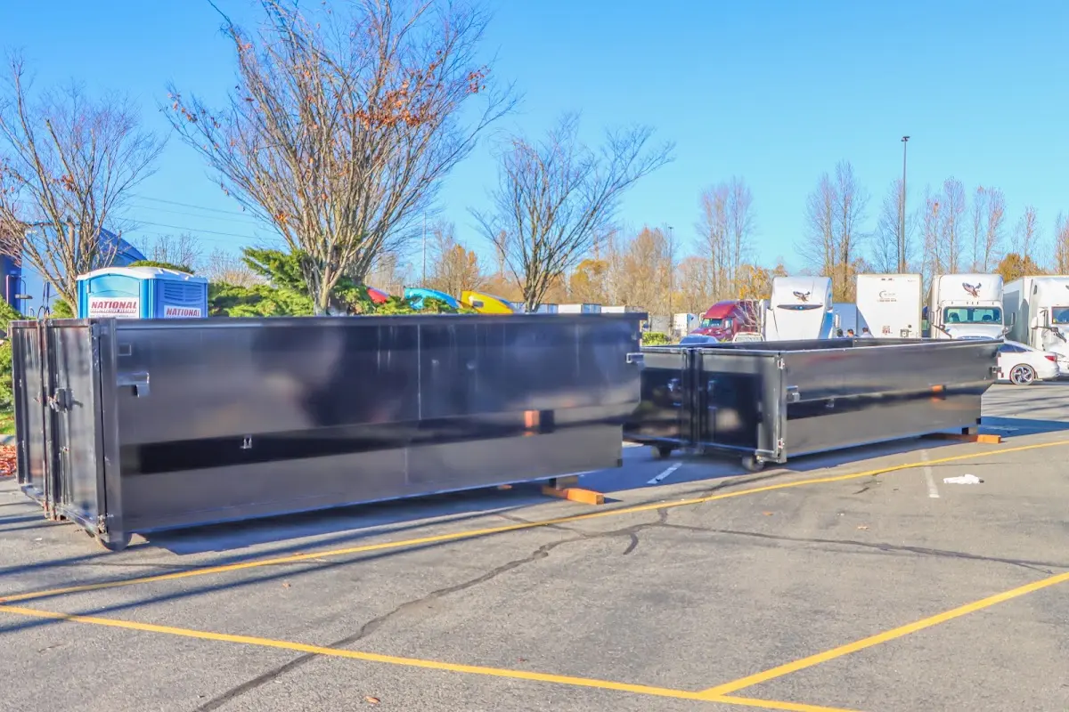 Professional dumpster rental service with roll-off container on residential driveway in Reminderville